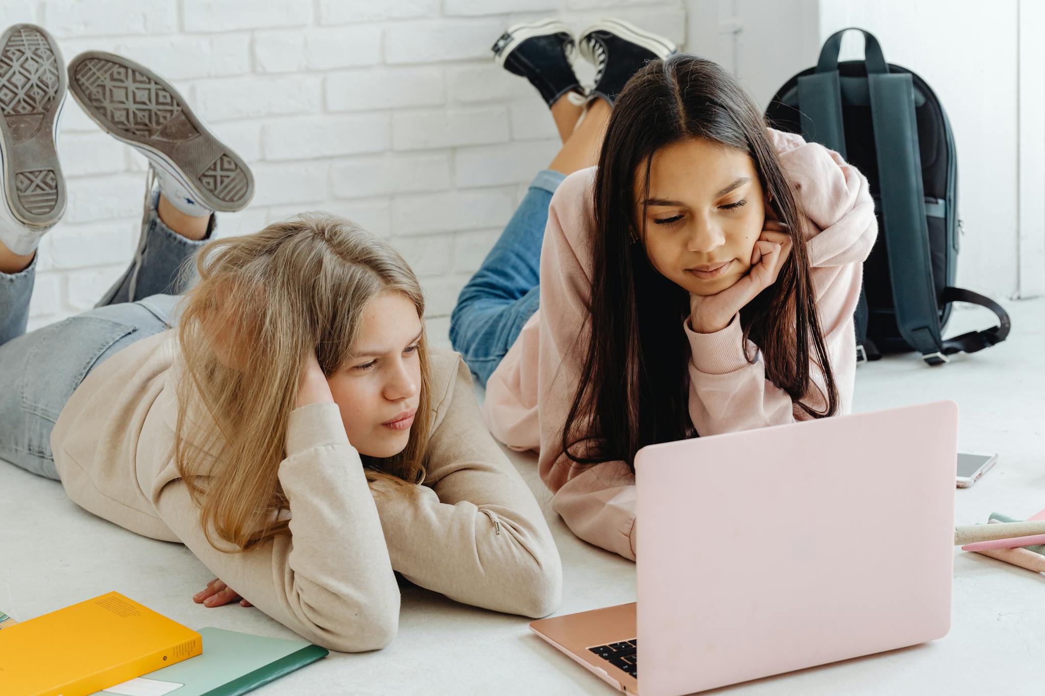 Two female students looking at a laptop linking to Associates of Arts in General Studies at Northeastern Baptist College